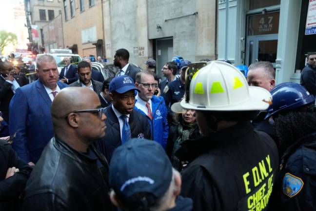 <b>New York City Mayor Eric Adams talks with fire officials on the scene of a parking garage collapse on Ann Street in Lower Manhattan on Tuesday, April 18, 2023.</b> Michael Appleton/Mayoral Photography Office