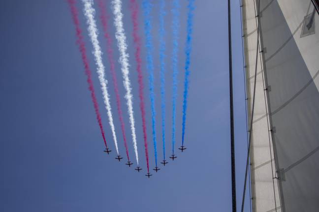 BAE Hawk jets flying over the Hudson River and leaving red, white, and blue vapor trails in the shape of the U.S. flag as part of the Sail4th 250 celebrations.