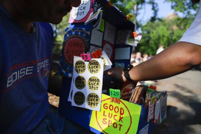 A customer reaching into Felix's portable store at Tomkins Square Park. Photo: Gabo Rodriguez-Tossas