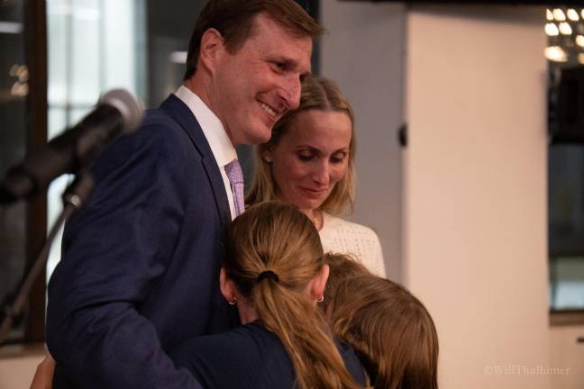 A final embrace on stage after the Congressman's speech left his wife and son in tears.