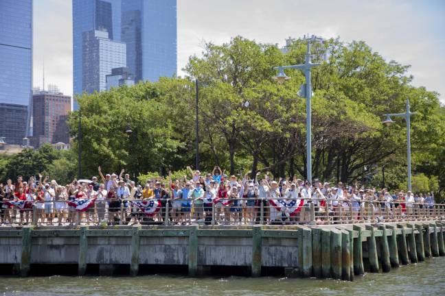 Crowds gathered at every pier along Chelsea in the heat, cheering at the sight of passing ships and aircraft.