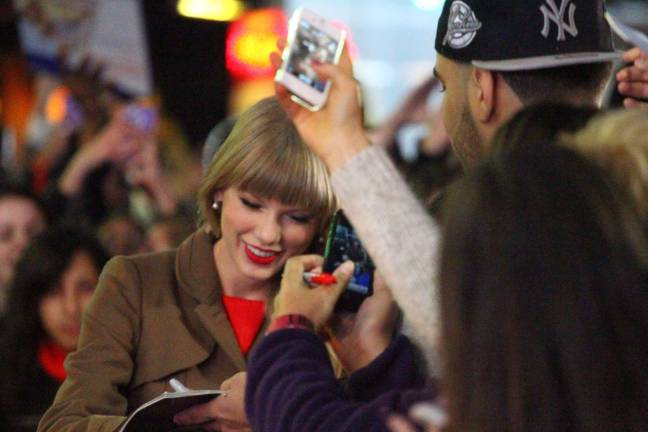 The singer Taylor Swift signing autographs in Times Square. Swift has been the subject of harrassment by a fan in New York City. Photo by paolopv.com