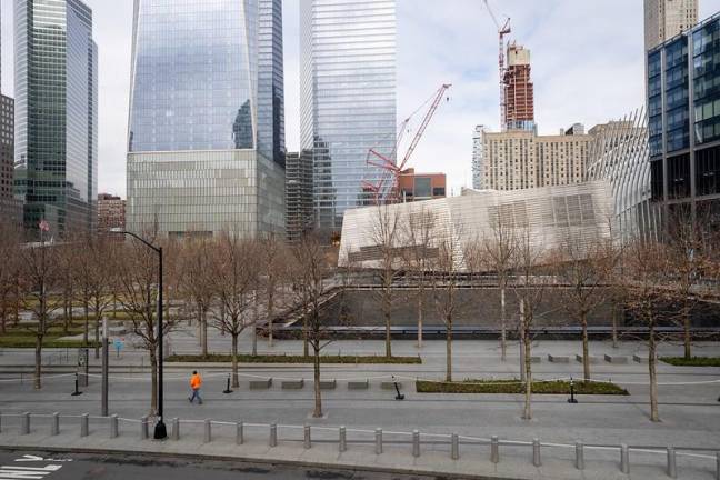 A construction worker passes by the 911 Memorial and Museum, closed to the public amid the COVID-19 spread, March 17, 2020.