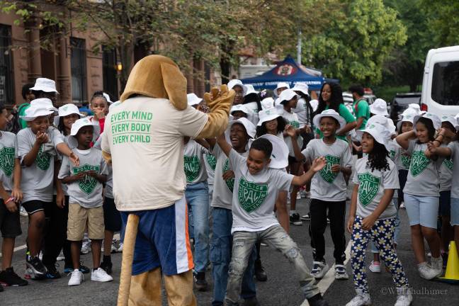 The PAL mascot dances with the children as they get ready for a day of fun.