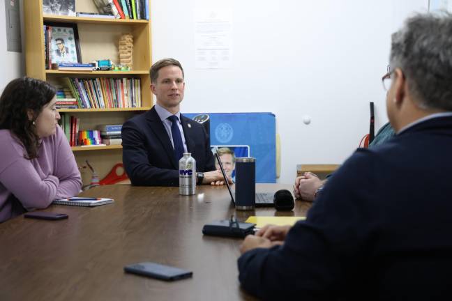 Erik Bottcher (center) at an earlier meeting at the Hudson Guild with its executive director Ken Jockers (right, back to camera). Working with the City Council member, the Hudson Guild hopes to triple the number of local residents finding work with some of the big tech and healthcare companies on the West Side.