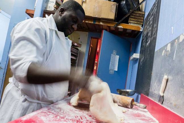 Kevin Smalls rolls out pastry dough. Photo: Maria Boyadjieva