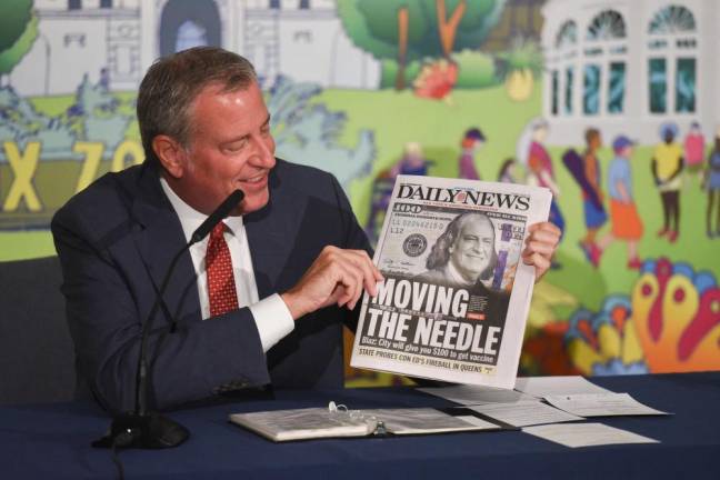 At a briefing on July 29, Mayor Bill de Blasio held up the Daily News highlighting his $100 incentive to get the vaccine. Photo: Michael Appleton/Mayoral Photography Office