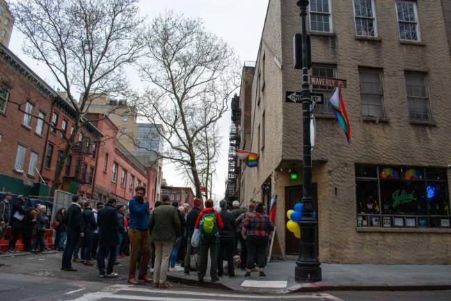 On West 10th Street, in front of Julius’ Bar, a crowd awaits the unveiling of the plaque honoring the “Sip-In” and the bar’s role in LGBTQ history. Photo: Leah Foreman