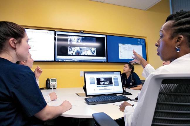 Kellie Bryant (right) with nursing students at the simulation center at Columbia University.