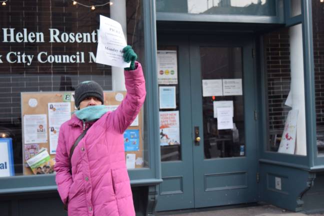 UWS resident Maria Fernandez hands out fliers outside Councilmember Helen Rosenthal's office, in protest of an expansion plan at the American Museum of Natural History that will cut into Theodore Roosevelt Park.
