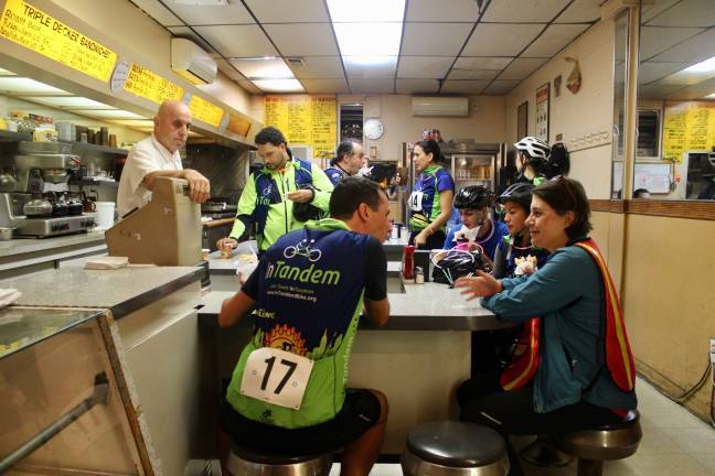 Cyclists, and their host, at Alpha Donuts in Sunnyside, Queens, the second stop during InTandem's Late Night Donut Ride on Sept. 29. Photo: Ariana Giulia Reichler