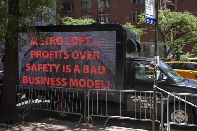 The Carpenters Union parked a box truck with LED signs outside the rally with messages reading “Crime Scene” and other provocative statements.