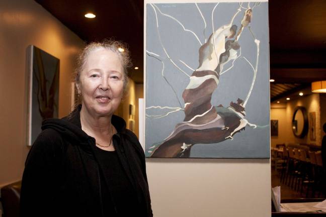 Artist Mary Hrbacek and her painting, &quot;Seizing Venus&quot; from her &quot;World Trees&quot; collection. Photo: Faye Nwafor