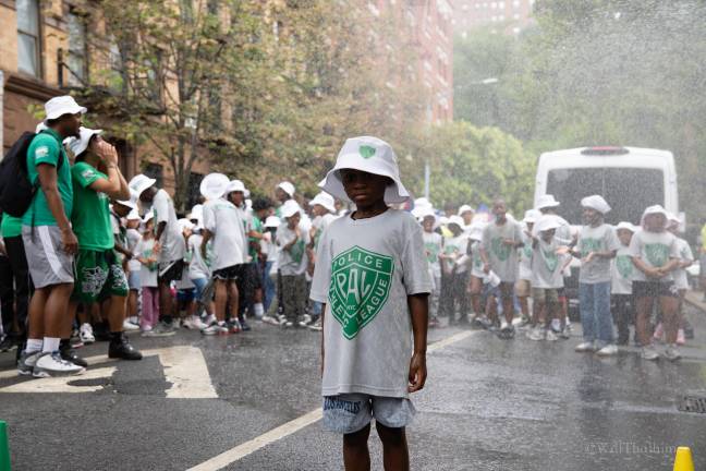 Three hundred young people take turns running and dancing under the hydrant.