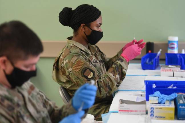 Medical members of the National Guard prepare Pfizer COVID-19 vaccines on February 24, 2021 at Medgar Evers College in Brooklyn, one of the New York State-FEMA mass vaccination sites. Photo: Kevin P. Coughlin / Office of Governor Andrew M. Cuomo