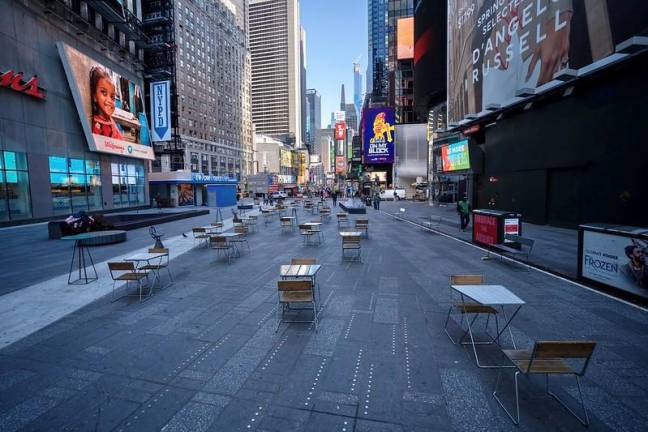 Times Square remains virtually empty after New York implements rules to restrict gatherings of more than 500 persons, March 16, 2020.