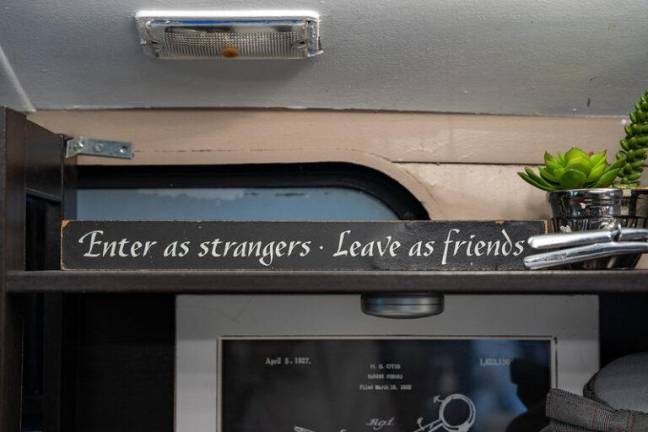 Sign that reads “Enter as Strangers. Leave as Friends.” Meek Young said she wants clients to know that a haircut experience with her will be genuine. Photo: Nathan Morris