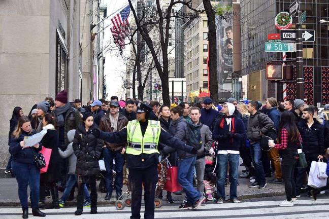 A throng of holiday shoppers and visitors waited for a light to change on Fifth Avenue near Rockefeller Center earlier this month. Photo: Andy Atzert, via flickr