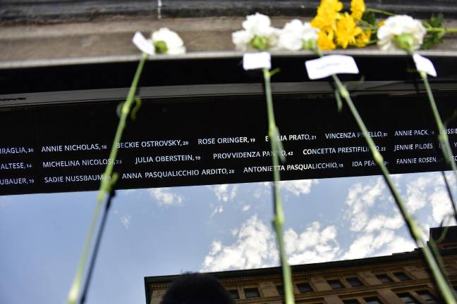 Flowers and names of the dead, Jewish and Italian both, at the Triangle Shirtwaist memorial.