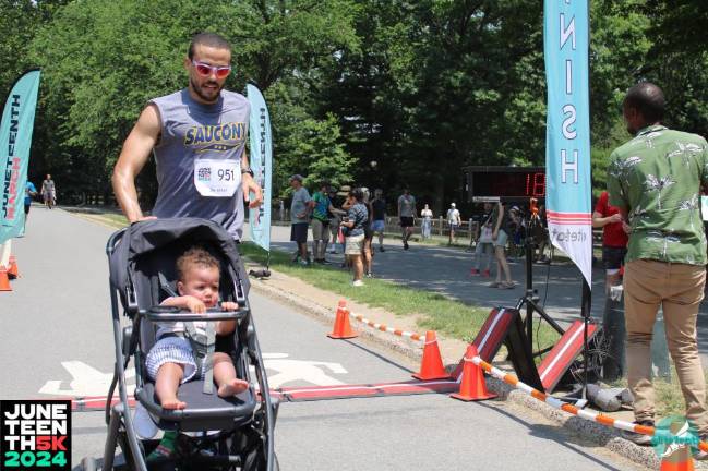 Man and baby at the Juneteenth 5K, 2024.