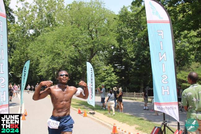 Flexing at the finish of the 2024 Juneteenth 5K.