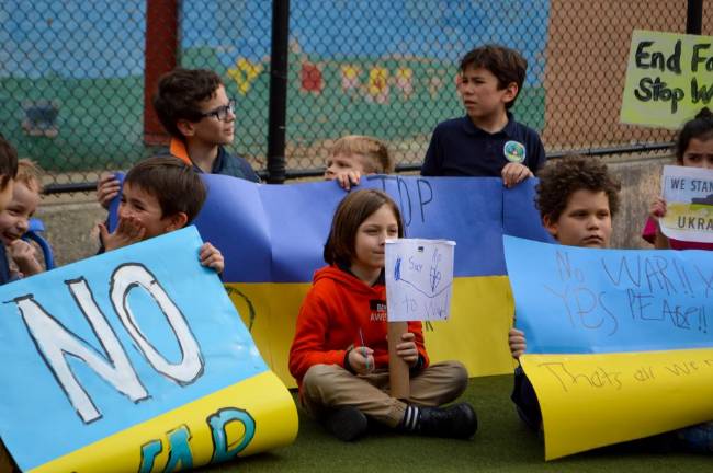 Young students held handmade banners and signs and some spoke to the crowd about their own ties to the conflict abroad. Photo: Abigail Gruskin