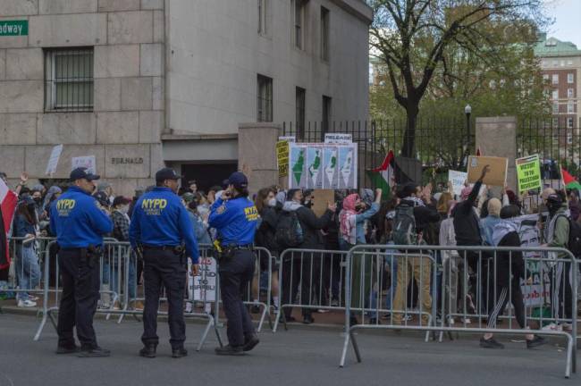 NYPD watches closely as protests surge outside the gates of campus. (Photo: Andrew McDonald).