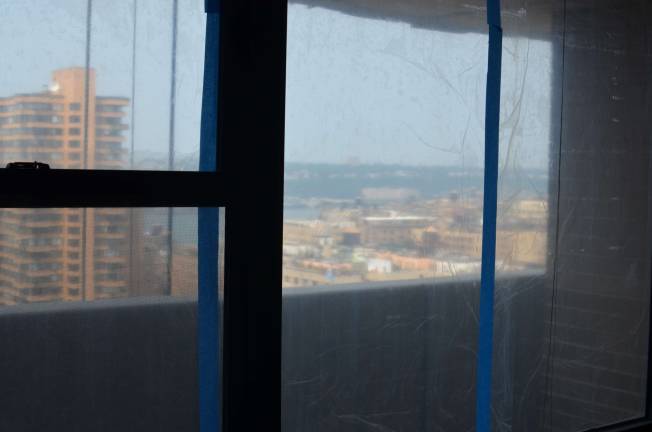 &#xa0;Gabriel Wimberly's windows covered in&#xa0;plastic sheeting, as seen from his living room.&#xa0;Photo: Daniel Fitzsimmons