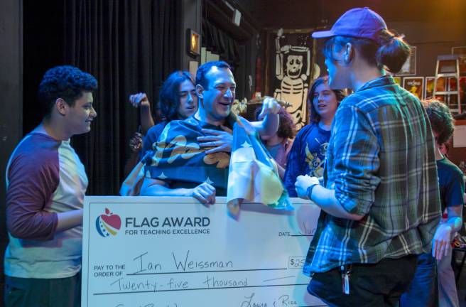 Mr. Weissman is greeted by cheering students who rush to congratulate him on his award.