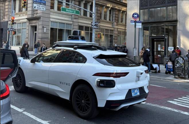 A Waymo robotaxi at Broadway and Walker Street, March 2026.