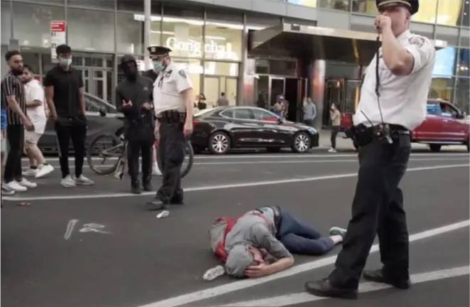 A victim on the ground after Times Square melee of May 20, 2021.