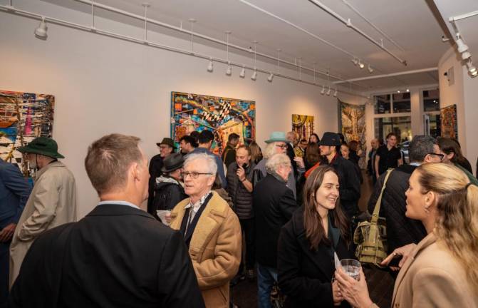 Reid Stowe (tan jacket, center) attracts a big crowd to opening night of his Oceanic Feelings exhibit March 23. His first solo show at Chase Contemporary in SOHO runs until April 16. <b>Photo: Chase Contemporary </b>
