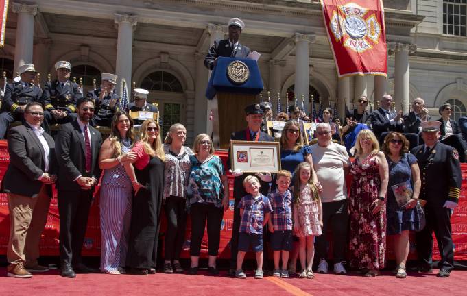Firefighter James Lafferty with his family, Mayor Mamdani, FDNY Commissioner Lillian Bonsignore, and FDNY Department Chief John Esposito. (Photo: Martina Dimitrova)