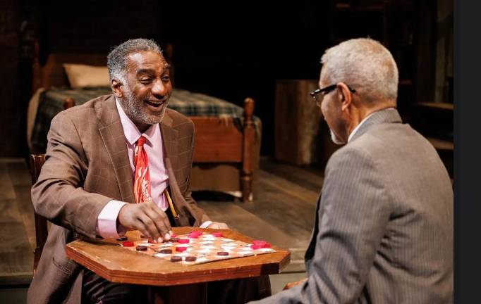 Norm Lewis (left) plays Russell Parker in a revival of the critically acclaimed <i>Ceremonies in Dark Old Men. </i>In his failing Harlem barbershop, he devotes his spare time to playing checkers with a friendly neighbor, played by James Foster Jr., while his daughter fumes. The family drama is now enjoying a limited run at the Theatre at St. Clements through May 18.