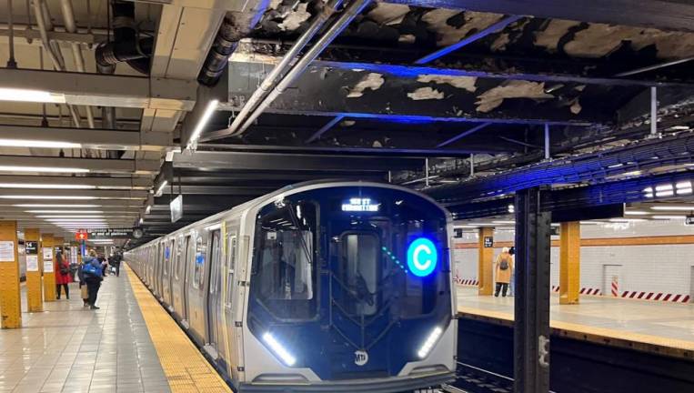 The NYC Transit’s newest train, one of two R211T open gangway trains that will ply the C train local line on the west side, pulls into the Eighth Avenue 14th Street Station. Photo: Ralph Spielman