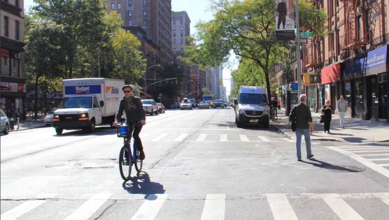 A bicyclist rides up Amsterdam Avenue, near at 78th Street. Photo: New York City Department of Transportation