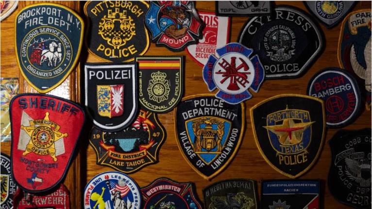 Members of uniformed services from all over the world leave their patches at O’Hara’s Pub near Ground Zero, Sept. 11, 2026.