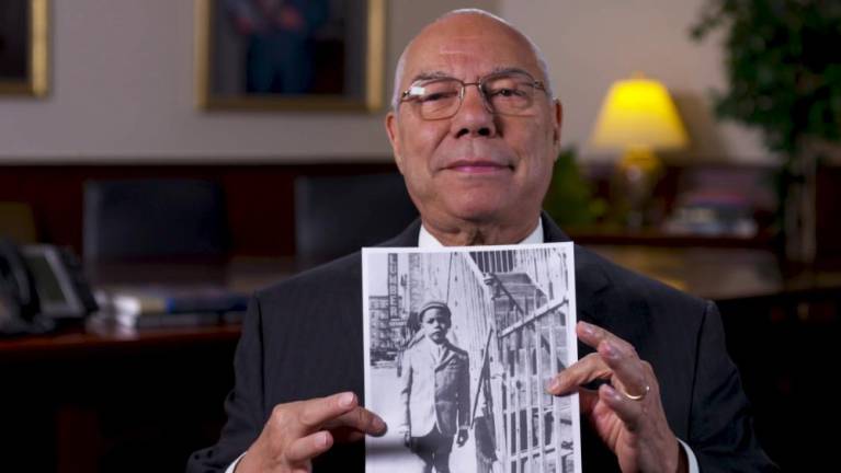 Colin Powell holding a photo of himself, c. 1943, in “The Automat.” Photo courtesy of A Slice of Pie Productions