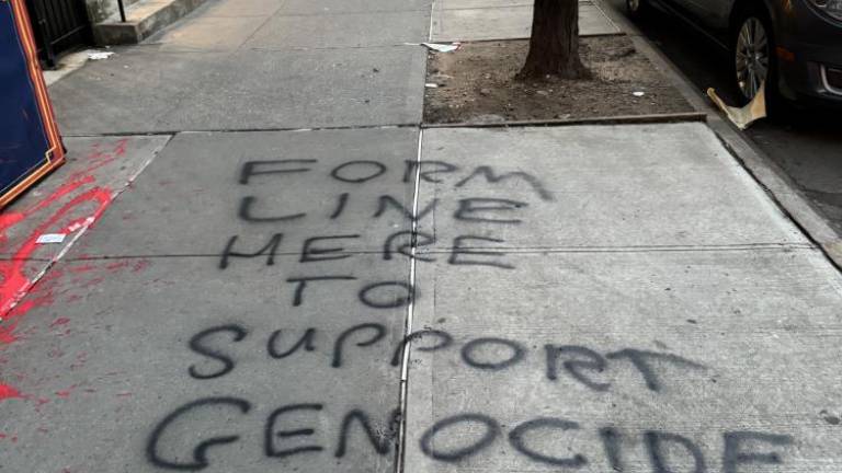 The outside of popular Jewish owned, Effy’s Cafe, located at 104 W 96th street in the Upper West Side, vandalized by anti-semitic hate crime written on the concrete with black graffiti paint saying “Form line here to support genocide” on March 18. Photo Credit: Ben Zara, manager at Effy’s Cafe.