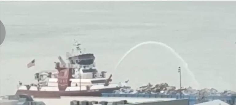 High powered hose on FDNY fire boat doses flames on a sanitation barge on Pier 99 on Aug. 27 just before 10 a.m.