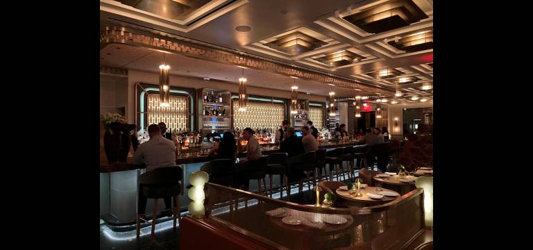 The lower level of the Waldorf Astoria’s Art Deco-inspired two-story Lex Yard restaurant has a bar and cozy lime-green-velvet booths.
