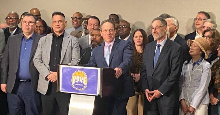 <b>Manny Pastreich (at mic) and Howard Rothschild (right of mic) surrounded by 32BJ Bargaining Committee the Realty Advisory Board members at New York Hilton Midtown. With only days before the old contract expired on April 20 and a strike loomed, a new contract was reached. </b>