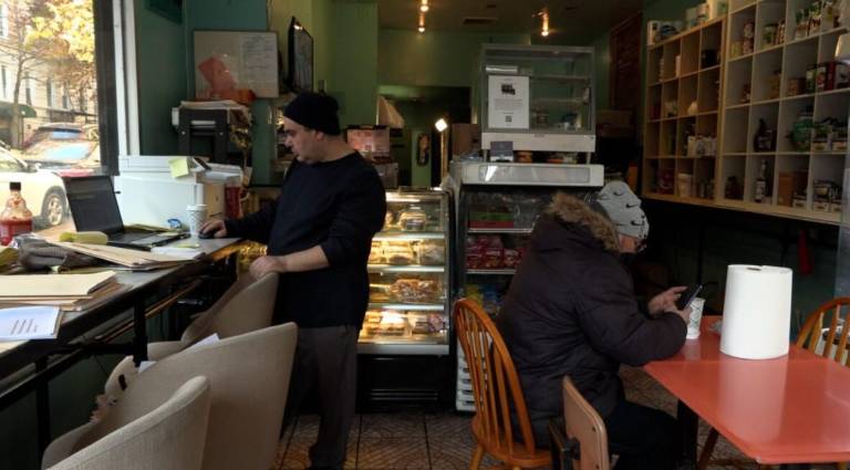 Yelhan Cingir (left) keeps a folder for the business, another for his brother’s medical records and for the legal papers as he battles a landlord trying to evict them from their last café near Columbia University.