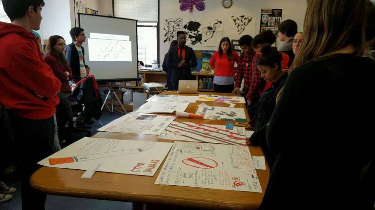 Ayo Alli, NYC Smoke-Free's youth engagement coordinator, and Marissa Allen, a guidance counselor at Smith School, speaking with students at Smith about anti-smoking strategies and posters the students designed on National Kick Butts Day. Photo: Brytnie Jones