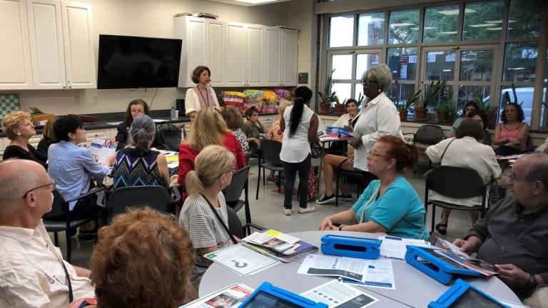 CB8 Census Committee Chair Loraine Brown (standing, right) and U.S. Census Bureau representative Joli Golden (standing, left) at a 2020 Census job opportunities workshop held at Lenox Hill Senior Center this summer.