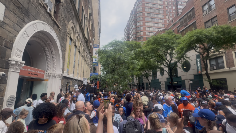 Children, parents, and caregivers gather outside the entrance of the Children’s Museum of Manhattan to celebrate the Knicks win with music, crafts, and other activities.