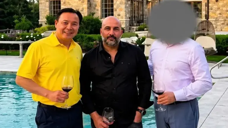 A photograph included in federal court filings shows Frank Carone (center) with Yan Po Zhu (left), owner of the Long Island City Microtel Inn at the center of the alleged bribery scheme. Zhu and Carone have both pleaded not guilty.