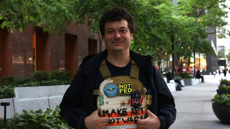 One attendee, Colin Johnson, is an artist. He kept the spirits high at the meetup, dressed for what he has coined the “Department of Vibe Management,” a long-running joke turned performance art. “It sounds like the vibes here need to be managed,” Johnson said.