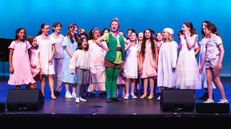 Camp Broadway’s 30th anniversary program presented songs and scenes from <i>Peter Pan</i> and <i>Catch Me If You Can</i> with an ensemble cast of 100 theater-loving kids from around the world. Featured player Katie Risko as Peter Pan performs with a group of Darling Children.