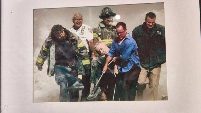 On display at the Fire Museum is the photo shot by Reuters photographer Shannon Stapleton showing the body of FDNY chaplain Father Mychal Judge carried by firefighters Christian Vaughn and Zachary Vause; NYPD Lt. William Cosgrove; Kevin Allen of the Office of Emergency Management and Goldman Sachs civilian and West Point graduate John Maguire.